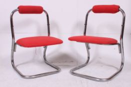 A pair of original 1970's chrome and red wool upholstered pair of cantilever dining chairs.