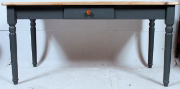 A contemporary painted pine scrub top country kitchen refectory dining table having painted base