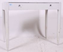 A mid 20th century Shabby Chic painted French desk raised on tapered supports having a fitted