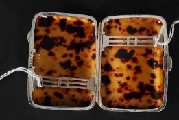 A silver hallmarked cigarette base having a tortoiseshell lining with pierced bandings inside.