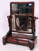 A 19th century Victorian toilet swing mirror in flame mahogany having plinth base with trinket