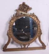 A 19th century Victorian Adams revival wall mirror having circular oval swag mirror with pierced