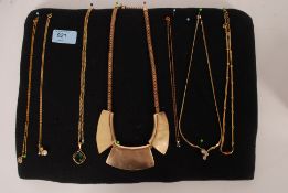 A collection of 7x gold plated / yellow metal necklaces including Egyptian style,