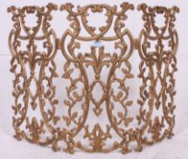 A very ornate 19th century gilt work scrolling cast metal fire guard of rococo form having triple