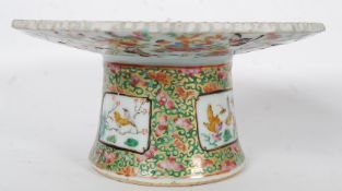 A 19th century Cantonese / Chinese ceramic tazza decorated with family / court scenes raised on