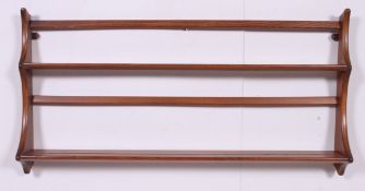 A retro 1970's Ercol beach and elm wall plate rack / plate rack being designed by Lucian Ercolani.