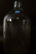 A large 20th century olive oil glass bottle having bulbous body with waisted neck