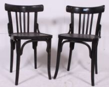 A pair of ebonised Bentwood chairs being made in Yugoslavia. Measures: 78cm x 41cm x 43cm.