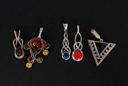 A collection of decorative silver pendants for necklaces to include amber set, paste stone,