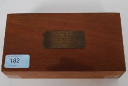 A vintage cigarette box bearing a plaque for H.M.