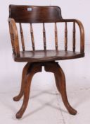 An Edwardian Arts & Crafts oak office desk chair.