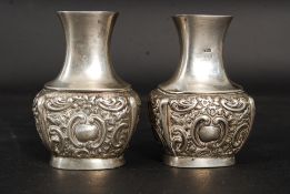 A pair of Victorian silver hallmarked miniature solifleur stem vases of rococo form bearing