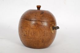 An antique style fruitwood apple shaped tea caddy - with hinged top, lined inner and original key.