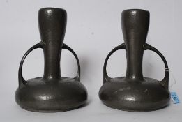 A pair of Art Nouveau early 20th century Walker & Co Homeland hammered pewter twin handled vases