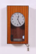 A retro Synchronome slave driver wall mounted electric clock. Opening glazed front, with pendulum.