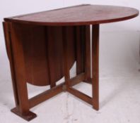 A vintage 1970's retro teak coffee table raised on tapered supports with shaped top above. 74.
