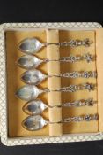 A collection of white metal ( marked 800 indicating silver content ) decorative topped spoons.