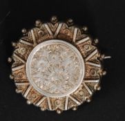 A stunning Victorian silver ladies brooch of rococo form being pressed in relief having chase