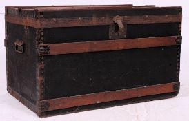 A vintage 20th century black steamer chest trunk having hinged top with lined interior and carry