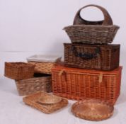 A stack of vintage whicker to include baskets, hampers, chests etc ( see illustration ).