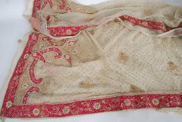 An Indian cream tissue silk shawl, with pink silk, pearl and gold thread decoration,