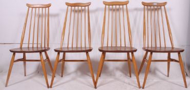 A set of 4 Ercol quaker pattern beech and elm dining chairs raised on turned legs united by