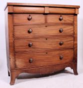 A 19th century Victorian Scottish mahogany chest of drawers being raised on kick bracket feet