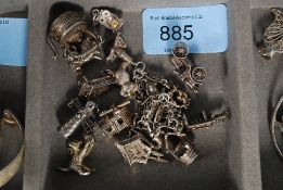 A silver 925 ladies charm bracelet complete with charms attached to include cherub, lighthouse,