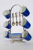 An unusual ceramic and silver plated coffee can stand having six blue glaze  cups and saucers along