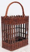 A 20th century whicker champagne basket. Of large form with carry handle atop.