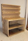 An early 20th century unusual small painted shabby chic dresser having an open base with plate rack