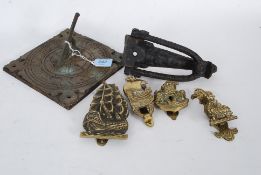 An antique style bronze sundial dated 1663 together with a cast iron ebonised door knocker together