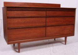 A good 1970's teak sideboard in the Danish style raised on tapered legs having flush set of 6