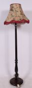 A 1930's mahogany standard lamp complete with the shade having reeded column over circular base.