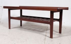 A 1960's Danish teak rectangular coffee table raised on squared supports having slatted underside