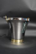 A Silver plated ice bucket with Brass strapping's. Weight: 1325.