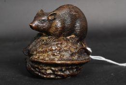 A charming possibly Vienna made bronze study of a mouse atop a large nut.