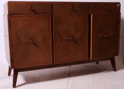 A 1950's walnut quarter veneer retro sideboard having a central row of cupboards having a series of