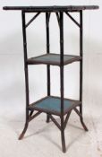 A Victorian ebonised aesthetic movement bamboo three tier table each square tier inset with a