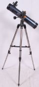 A Celestron Astro Master telescope on tripod base.