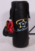A 20th century Punchbag complete with the metal bracket wall mount and gloves.