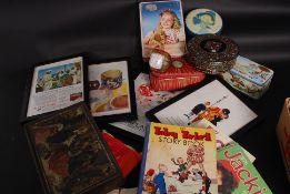 A collection of vintage tins, postcards,
