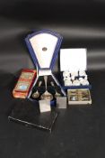 A selection of boxed flatware along ith an angular retro stainless steel cruet set