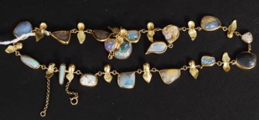 A ladies 18ct gold and opal stone set necklace. The petal style gold interspaced with 17 opals.