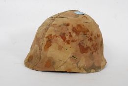 An original 20th century Vietnam military helmet, with leather inner, and original canvas straps.