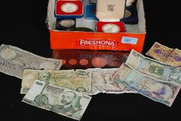 A collection of commemorative coins to include crowns, and banknotes etc.