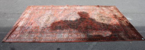 A large 20th century Persian carpet with central medallions having red ground and geometric borders