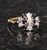 A 9ct gold ladies ring interspersed with small diamond chips and garnet stones. weight 1.