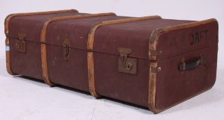 An early 20th century brown de-mob canvas and wooden bound steamer trunk with clasps to centre.