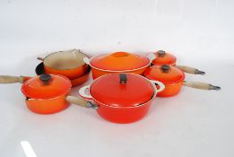 An 8 piece set of Le Crueset comprising of eight pieces and six lids.